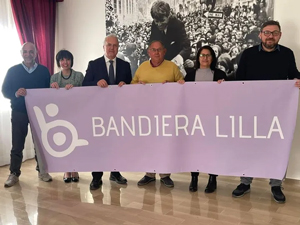 Rappresentanti del comune di Rocca Lumera posano con il presidente di Bandiera Lilla Roberto Bazzano e uno striscione dell'associazione
