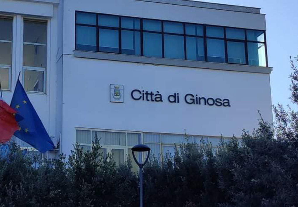 La facciata del Comune, un palazzo moderno con intorno alberi