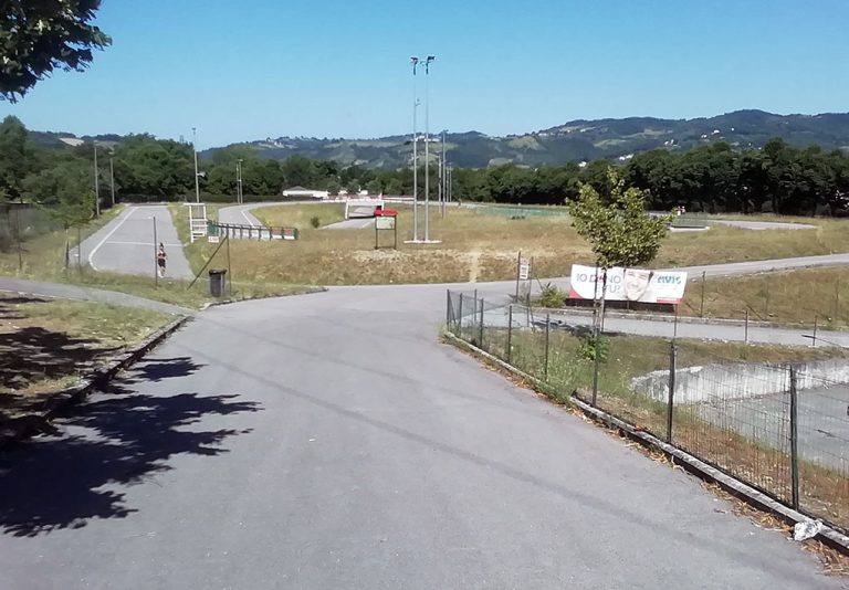 pista ciclodromo con piste e barriere di sciurezza. Paesaggio collinare come fondo.